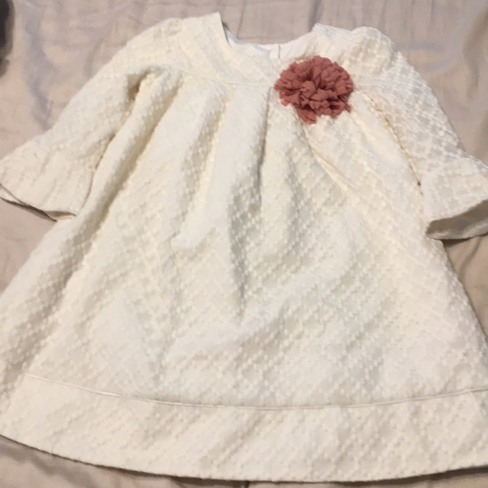 Cream dress with flower detail.